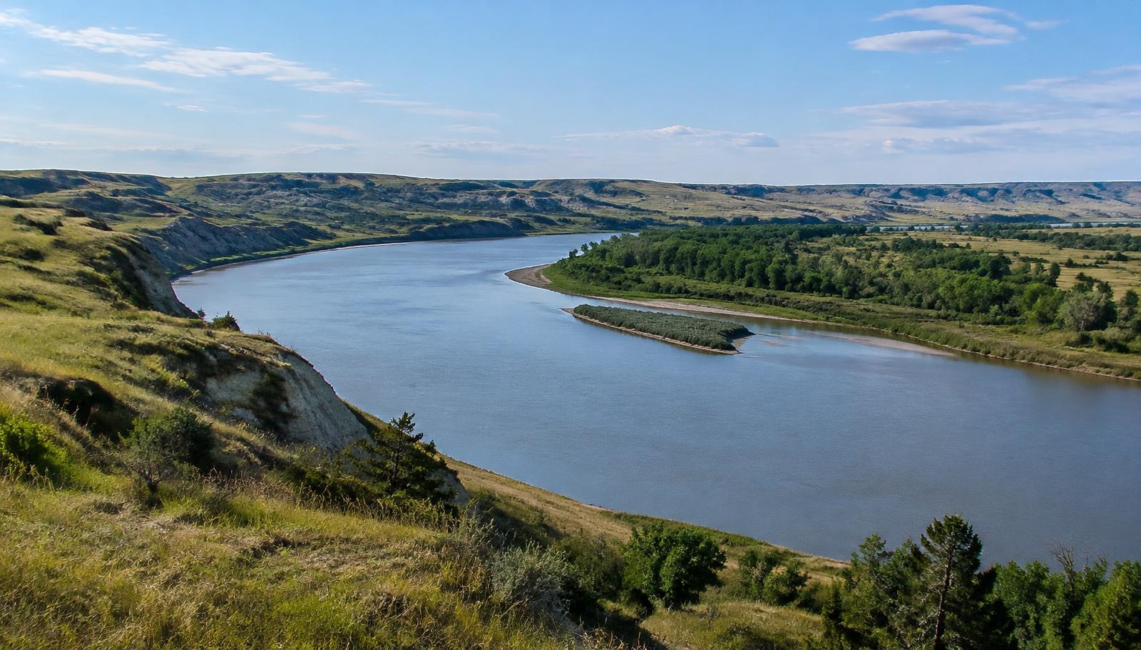 Missouri River between grassy bluffs